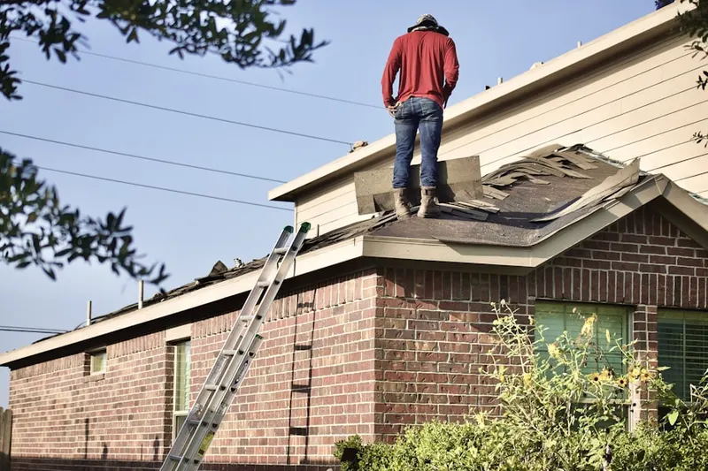 Professional roofer working on a residential roof in Stonycrest